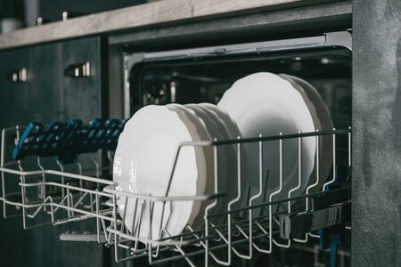 Close-up of plates in the dishwasher. Household chores and washing dishes.の写真素材