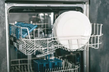 Close-up of plates in the dishwasher. Household chores and washing dishes.の写真素材