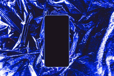 Cell phone mockup with blank screen or copy space on trendy neon background.の写真素材