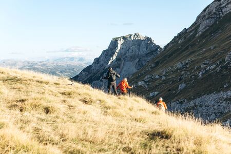 A group of people or tourists or backpackers on a background of mountains in the north of Montenegro.の写真素材