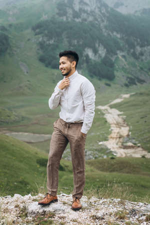 Portrait of a handsome positive young Kazakh man on a background of nature.の写真素材
