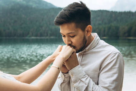 Kazakh groom gently kisses the hands of his brideの写真素材
