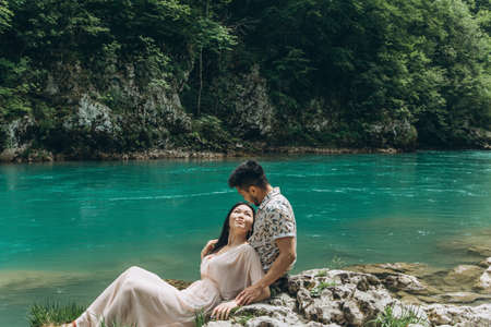 A young couple by the river together.の写真素材