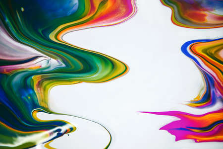 Multicolored acrylic paint flowing fluid trend bright colorful background.の写真素材