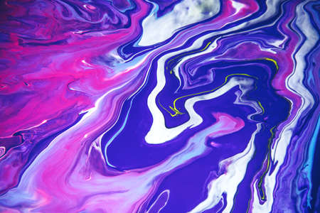 Acrylic paint liquid in trend purple and blue color mix background.の写真素材