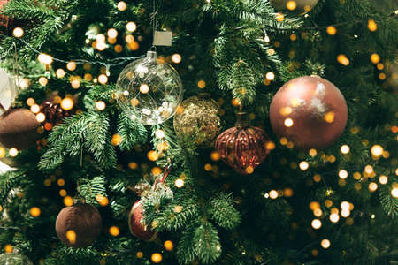 Christmas festive green tree with many balls and festive lights. Christmas background.の写真素材