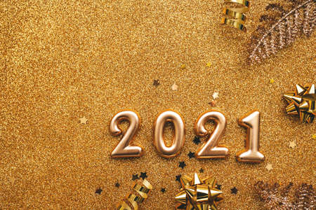 Gold numbers 2021 on a golden rich festive background. Celebrating New Year and Christmas concept.