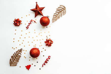 Gold and red Christmas items on a white background. Christmas or New Year conceptual background. There is empty space for text nearby.の写真素材