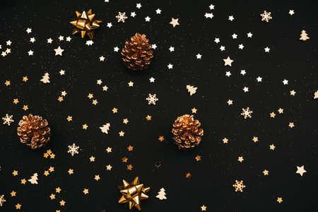 Festive dark background with many golden Christmas and New Year decorations, stars and cones.の写真素材