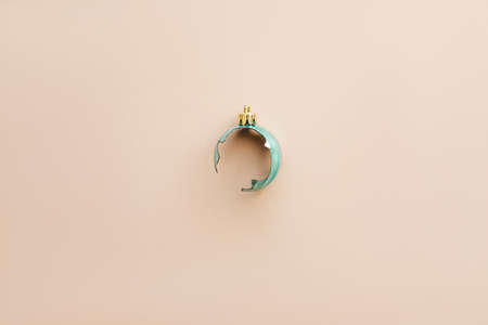 Broken Christmas tree toy ball on a pink background in a minimal style.の写真素材