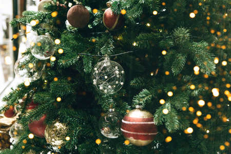 Christmas festive green tree with many balls and festive lights. Christmas background.の写真素材