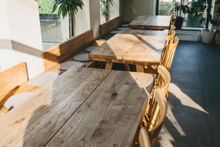 Empty wooden tables and chairs. Rustic interior.