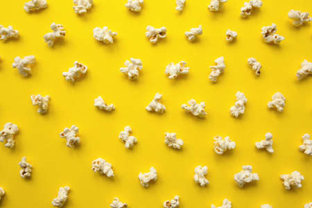Popcorn scattered on yellow background. Popcorn pattern. top view.の写真素材