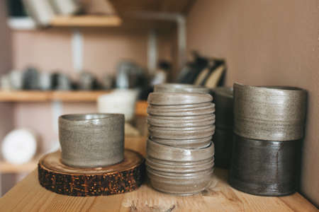 Pottery workshop products on table close up. Handmade, creativity and hobby concept.の写真素材