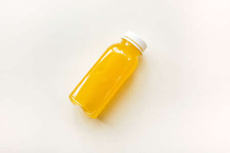 Bottles of freshly squeezed orange juice on a white background. The concept of a healthy diet, detox or dietの写真素材