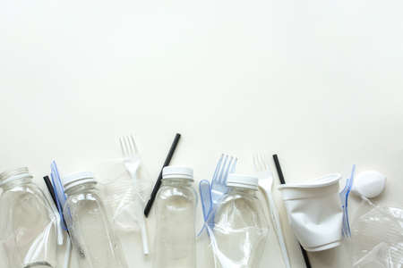 White plastic garbage on a white background. The concept of plastic recycling and ecology. Plastic...