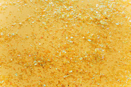 Beautiful festive white background with golden confetti. Flat lay, top view.の写真素材