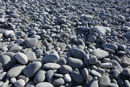 Rocky, stony nature and texture of a beach on the North Island of New Zealandの写真素材