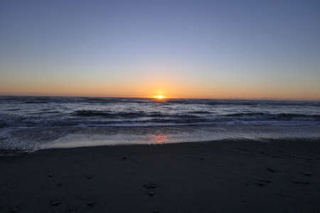 Far advanced sunset on a beach in New Zealandの写真素材