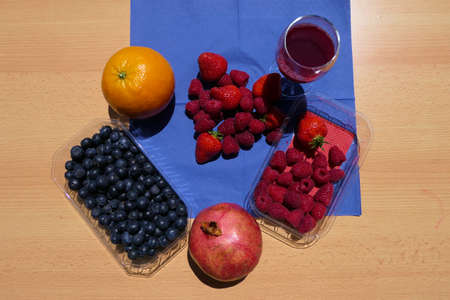 Healthy life - fruits, berries and fruit juice on a wooden tableの写真素材