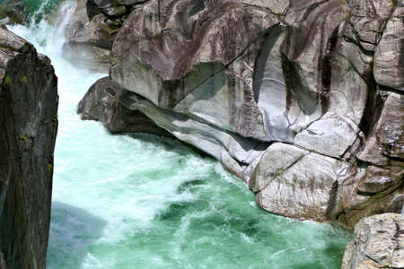 Closeup of the green Verzasca River and abraded rocks in Valle Verzasca valley in the Locarno district of the Canton of Ticino in Switzerlandの写真素材
