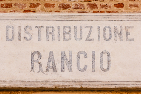 sign made of cement indicating the writing ration-distribution  on a bricks wallの写真素材