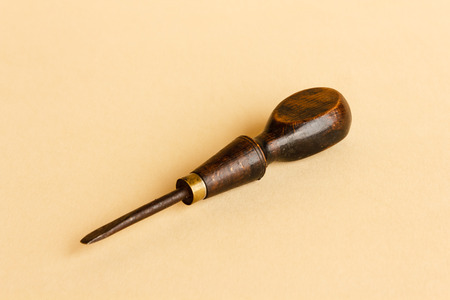 old screwdriver with a wooden handle and metal tip of the eighteenth century