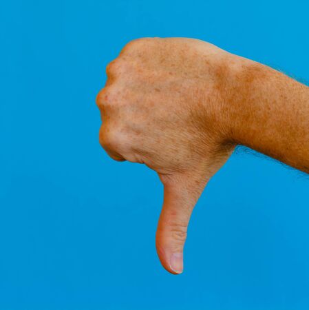the gesture of the hand of the inverted thumb to express the meaning of adversity and condemnation