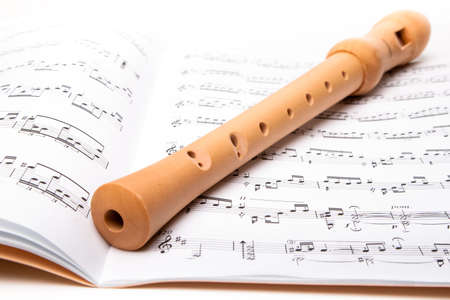 Wooden flute on sheet music. Close up.の写真素材