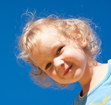 portrait of child on blue backgroundの写真素材