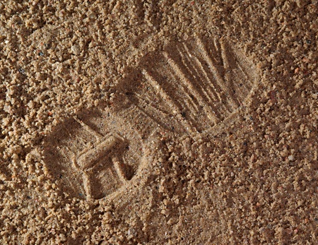 sandy surface  boot-print  gravel close upの写真素材
