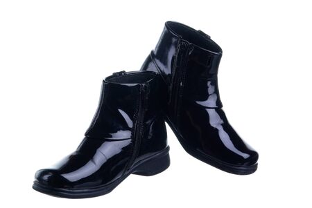 a couple of black chilsren's shoes isolated on white backgroundの写真素材