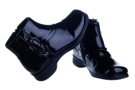 a couple of black chilsren's shoes isolated on white backgroundの写真素材