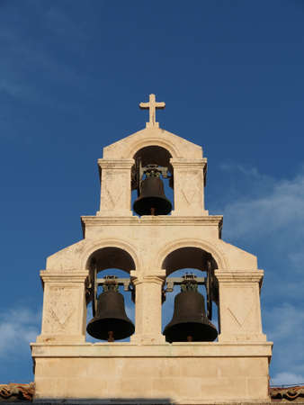 stone bell tower with a blue sky backgroundの写真素材