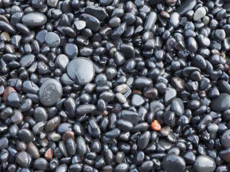 background of wet basalt pebbles from Vik shore, Icelandの写真素材