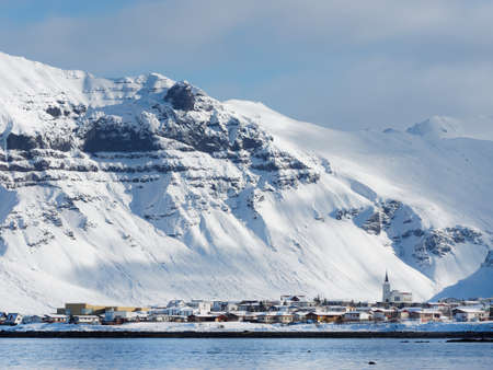 Grundarfjordur small coastal town in SnÃ¦fellsnes peninsula north side, Iceland, with snow covered mountains in the background.の写真素材