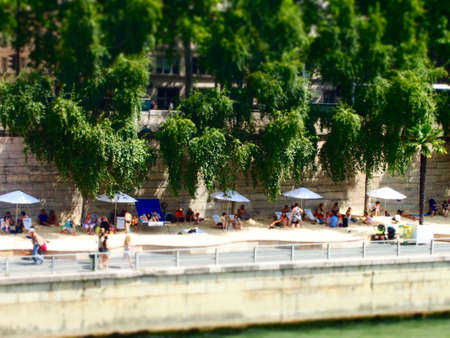 Sunbathers alongside the Seine River , Paris Franceの写真素材