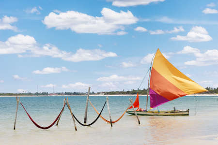 beautiful sail boat and hammocks at the Paradise Lake  Jericoacoara, Brazil の写真素材