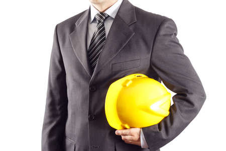 businessman or engineer holding a helmet under his arm against white backgroundの写真素材