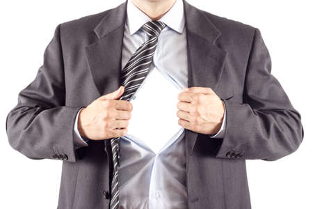 Businessman in classic superman pose tearing his shirt open to reveal blank copy space on chestの写真素材