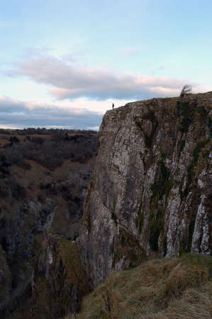 Lonely hicker standing at the top of Cheddar cliffs, UK. Great view of the Gorge.の写真素材
