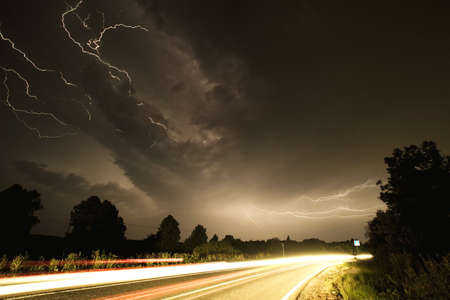 A lot of lightnings over the road at night, this is a compilation of 5 photographs 