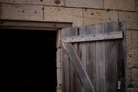 An old wood door opened on a barnの写真素材