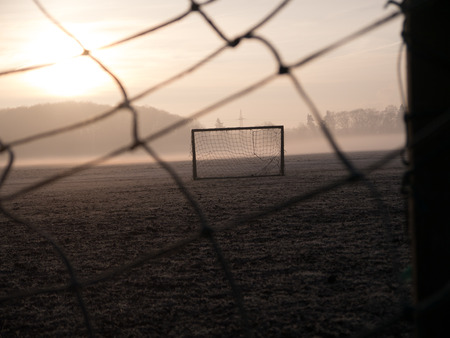 Beautiful foggy soccer pitch on a field at sunriseの写真素材