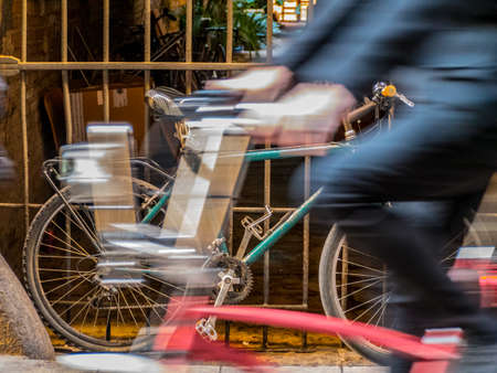 Man riding a bike in motion blur.