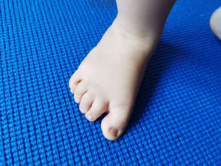 Baby foot over blue background.