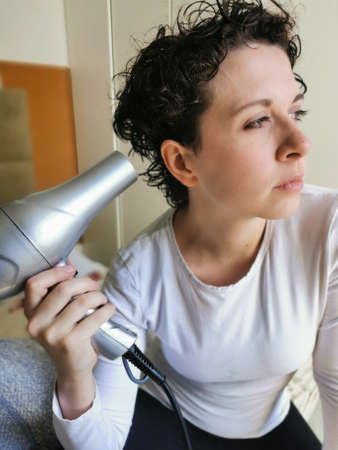 Fashion Curly Haired Woman Drying her hair.の写真素材