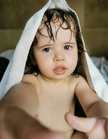 Girl playing with towel on head after bath.の写真素材