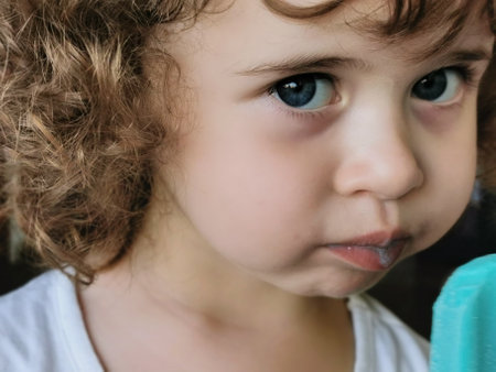 Little girl enjoying her blue ice cream.の写真素材