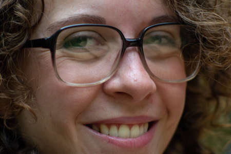 Brazilian Curly haired woman looking at the camera.